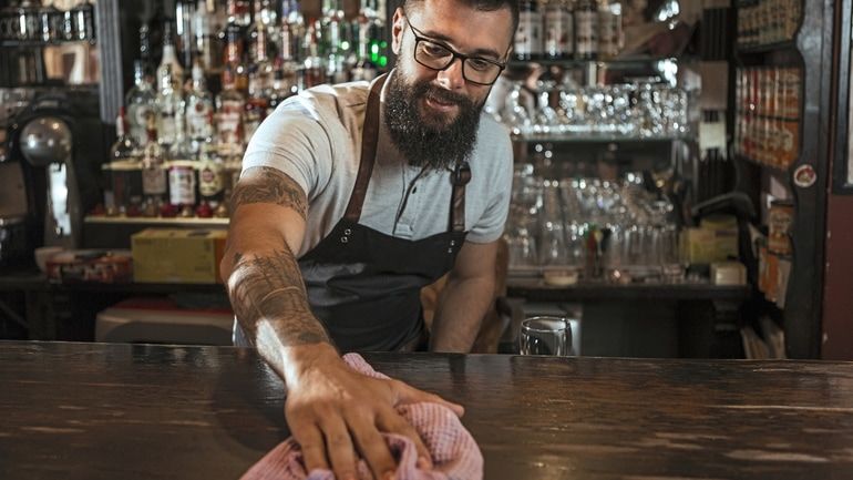 Bartender cleaning a bar counter