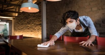 Restaurant employee wiping a table