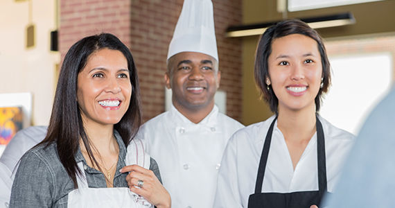 Photo of 3 restaurant employees smiling
