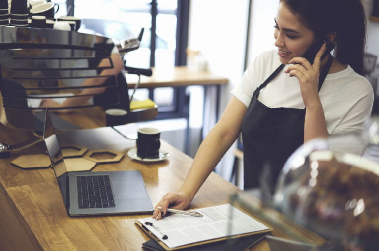 Female restaurant worker on the phone