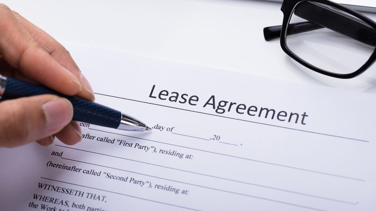 Person filling lease agreement paper work