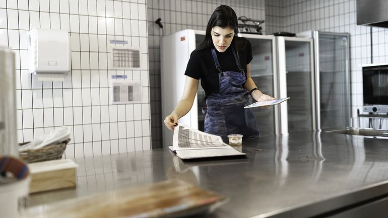 Female business owner checking kitchen supplies