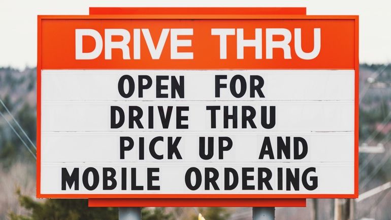 Drive-thru signage promoting pick-up and mobile ordering during the COVID-19 pandemic
