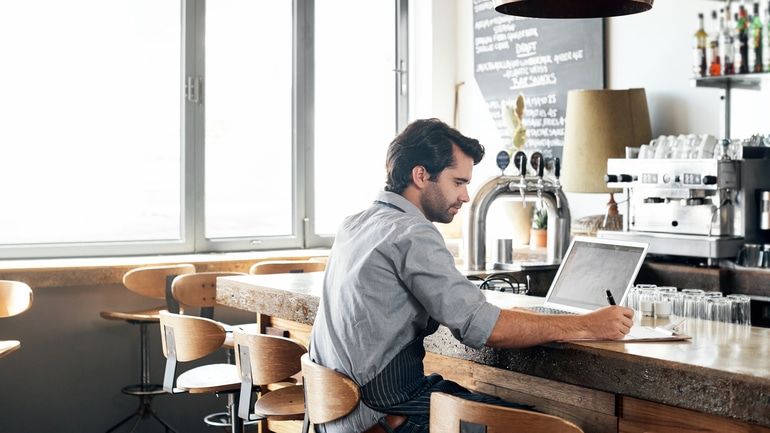 Restaurant owner working on a laptop