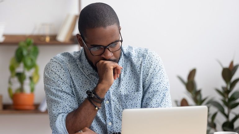 man looking for news update on his computer