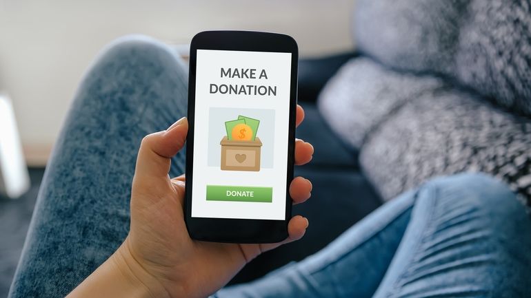 Person making a donation on their smart phone