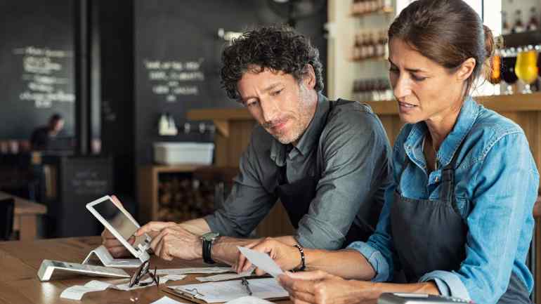 two staff members analyzing marketing reporting