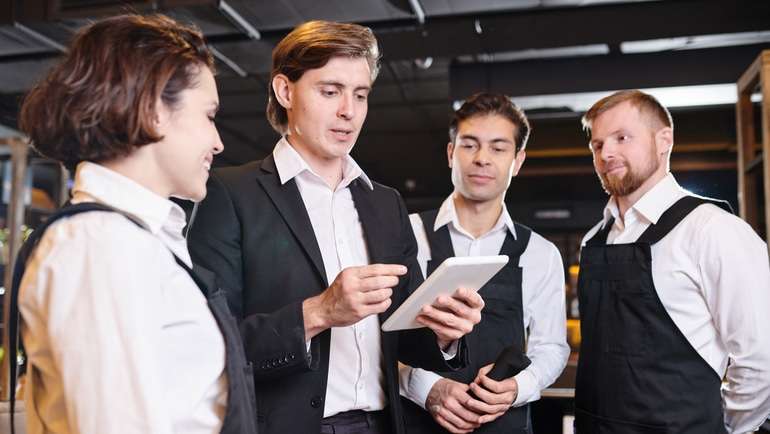 Restaurant manager talking to staff