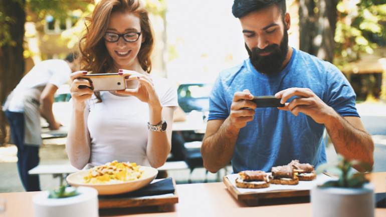 Diners photographing their meals with their smartphones