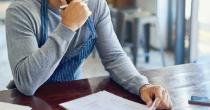 restaurant owner looking at credit card statement