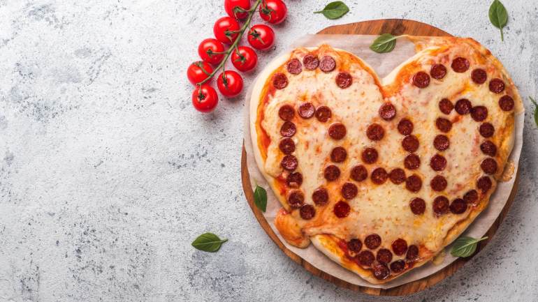 Heart shaped pizza with dad spelled out in pepperoni
