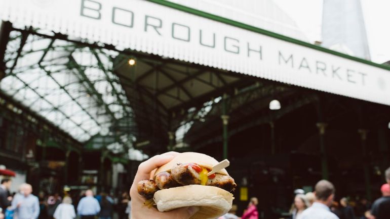 Burger held up against food hall back drop