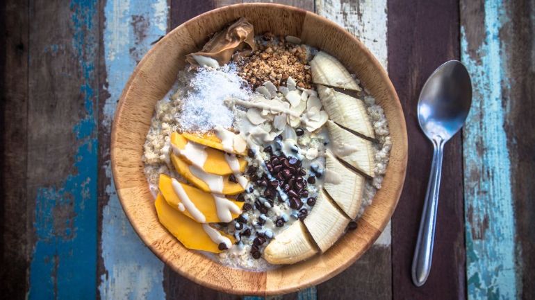 Breakfast bowl with grains and sliced fruit