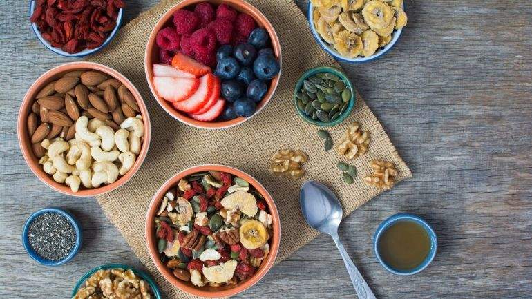 Bowls of nuts seeds and fruit