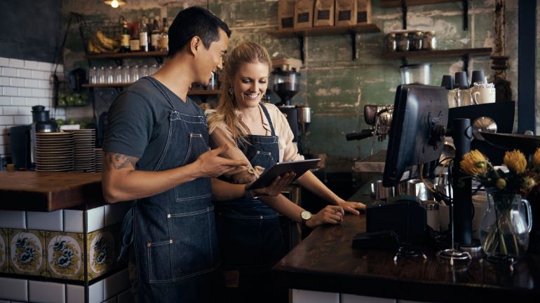 Restaurant employees looking at tablet POS