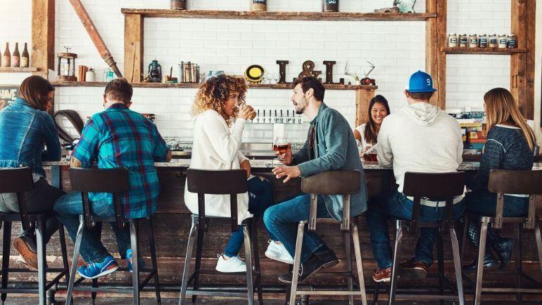 Friends having a conversation at a bar