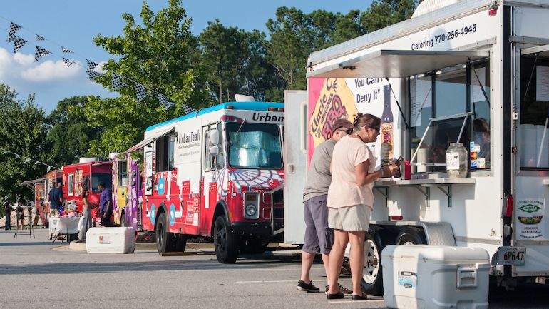 Customers placing an order at a food truck fair