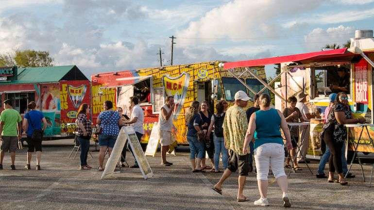 Customers wandering at a food truck fair