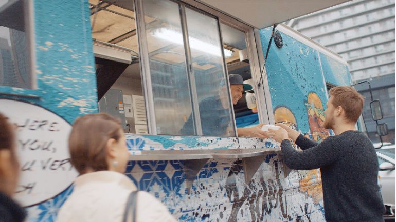 Matt basile serving a customer out of food truck window