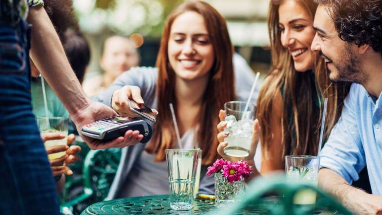 A customer paying with her phone