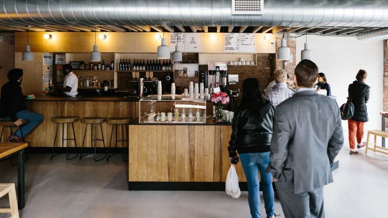 Customers waiting in line to place coffee orders