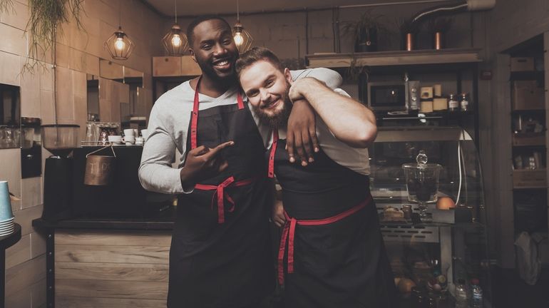 Two restaurant workers smiling for a photo
