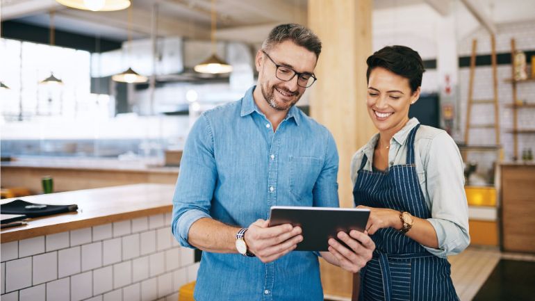 Restaurant staff consulting tablet