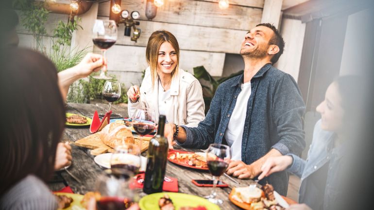 A group of friends eating outdoors on a patio