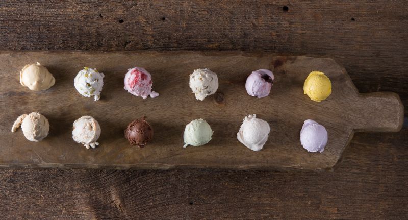 Wooden board featuring a flight of ice cream flavours to sample.