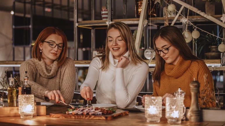 Three friends sharing an appetizer