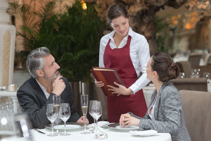 Server visiting a table to take their order