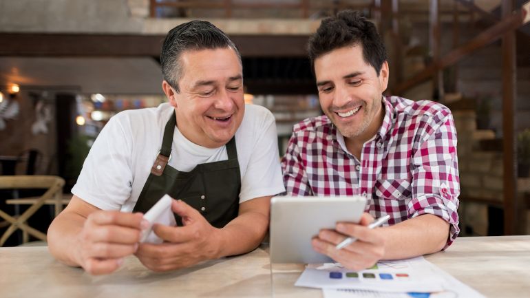 Two restaurant workers reviewing financial details