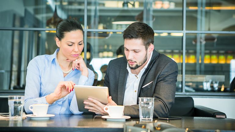 Two restaurant workers reviewing financial details