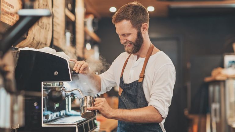 Barista steaming milk