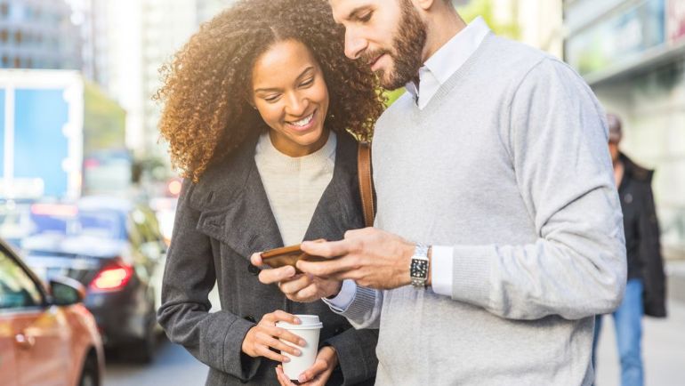 Friends on the street checking their phone