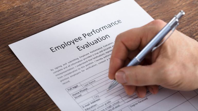 Restaurant manager filling out an employee performance evaluation form