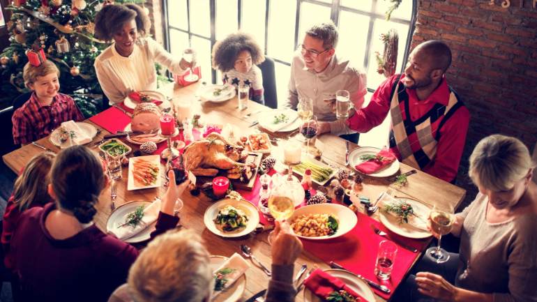 Family and friends gathered around a holiday table