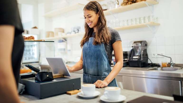 Server taking order at cafe counter