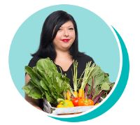 Erica holding a basket of produce