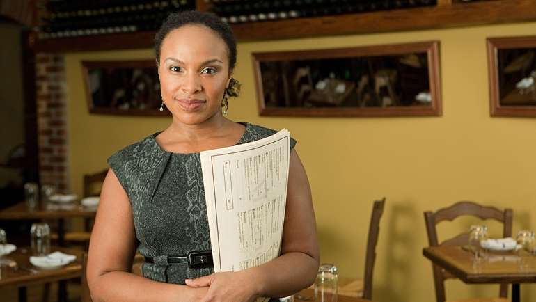 Restaurant manager holding menus