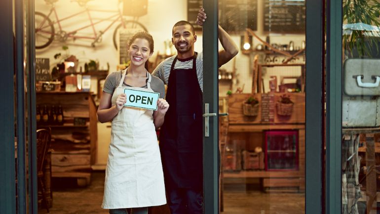 Employees standing at the entrance to their restaurant