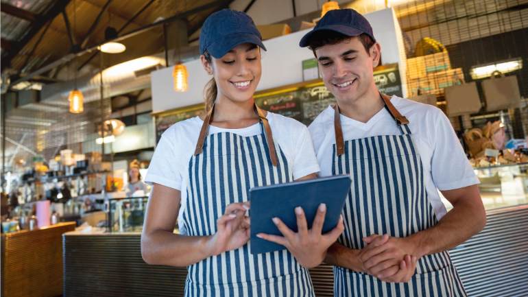 Restaurant employees working together on a tablet