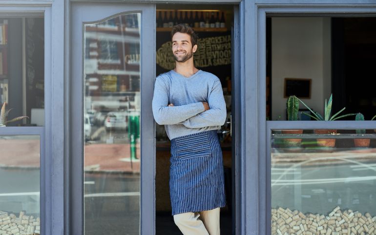 employee standing at entrance of restaurant