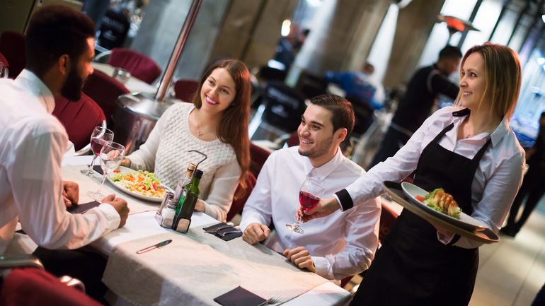 Server delivering food and drink to a table