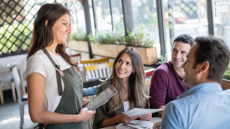 Smiling server taking an order