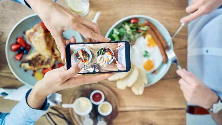 customer taking photos of two dishes