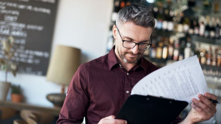 Restaurant manager looking at schedule