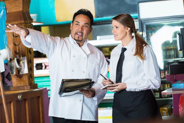 Chef talking with restaurant server