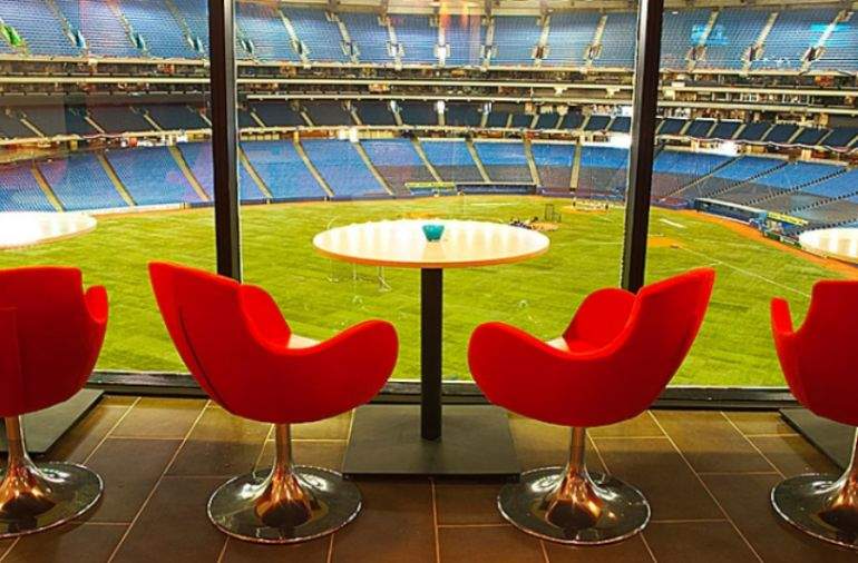 Seats overlooking baseball field for Arriba restaurant in Toronto
