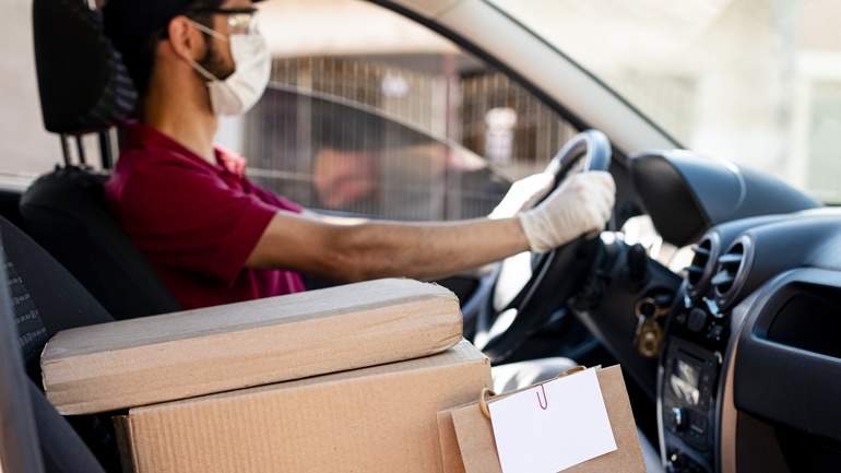 Delivery driver in the car with mask and gloves
